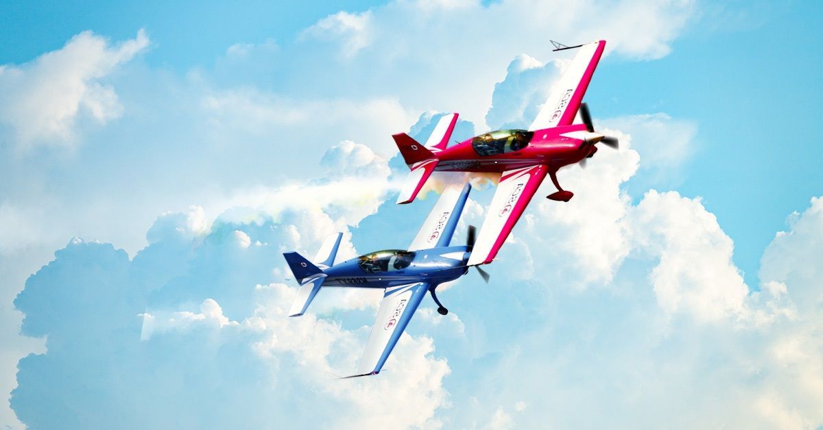 A red and blue plane fly from Sky Combat Ace next to each other.
