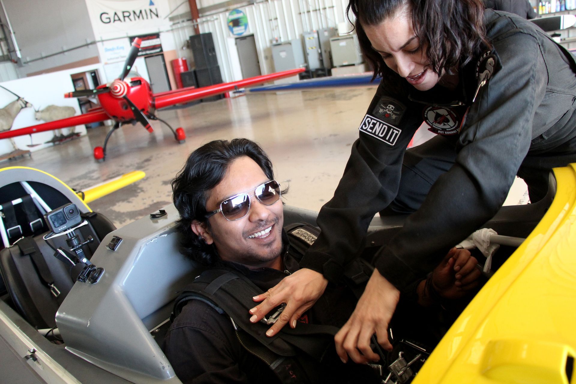 Getting strapped in to the Extra 330LC, the world's most advanced FAA certified stunt plane