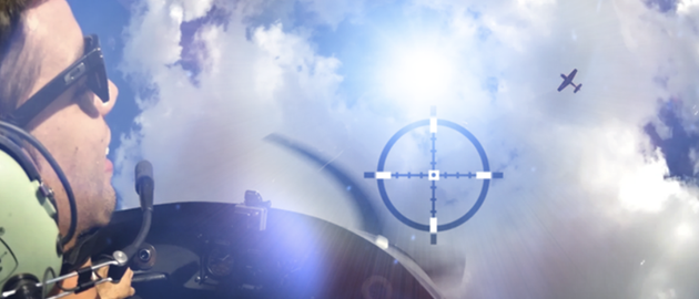 A man in a helmet is looking at a target in the sky.