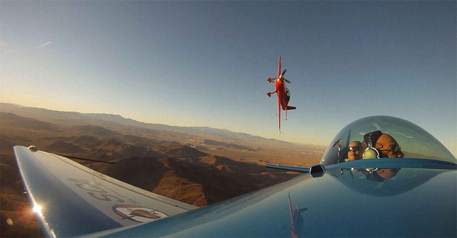 Two planes in the air from Sky Combat Ace, one is mid-roll. 