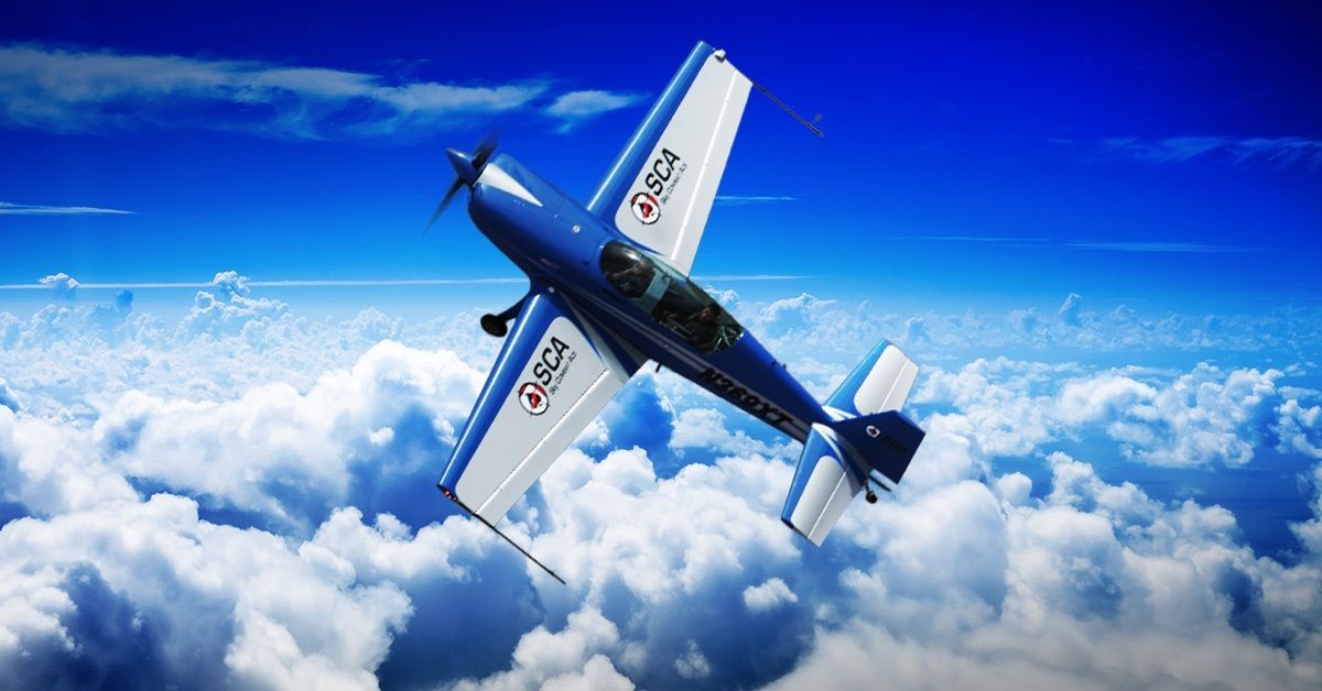 A blue Sky Combat Ace plane flying above the clouds.