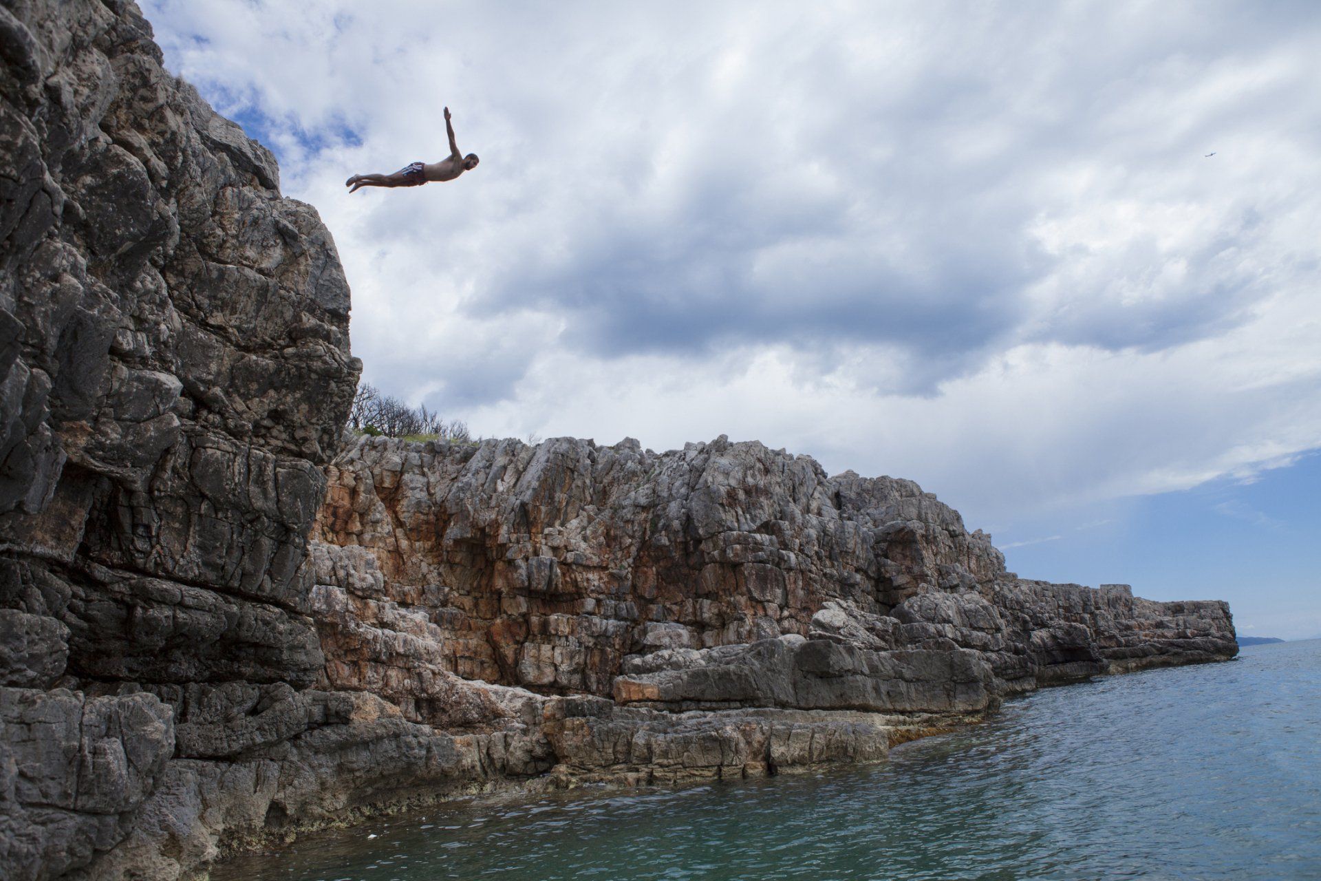 Adrenaline junkie jumping off a cliff