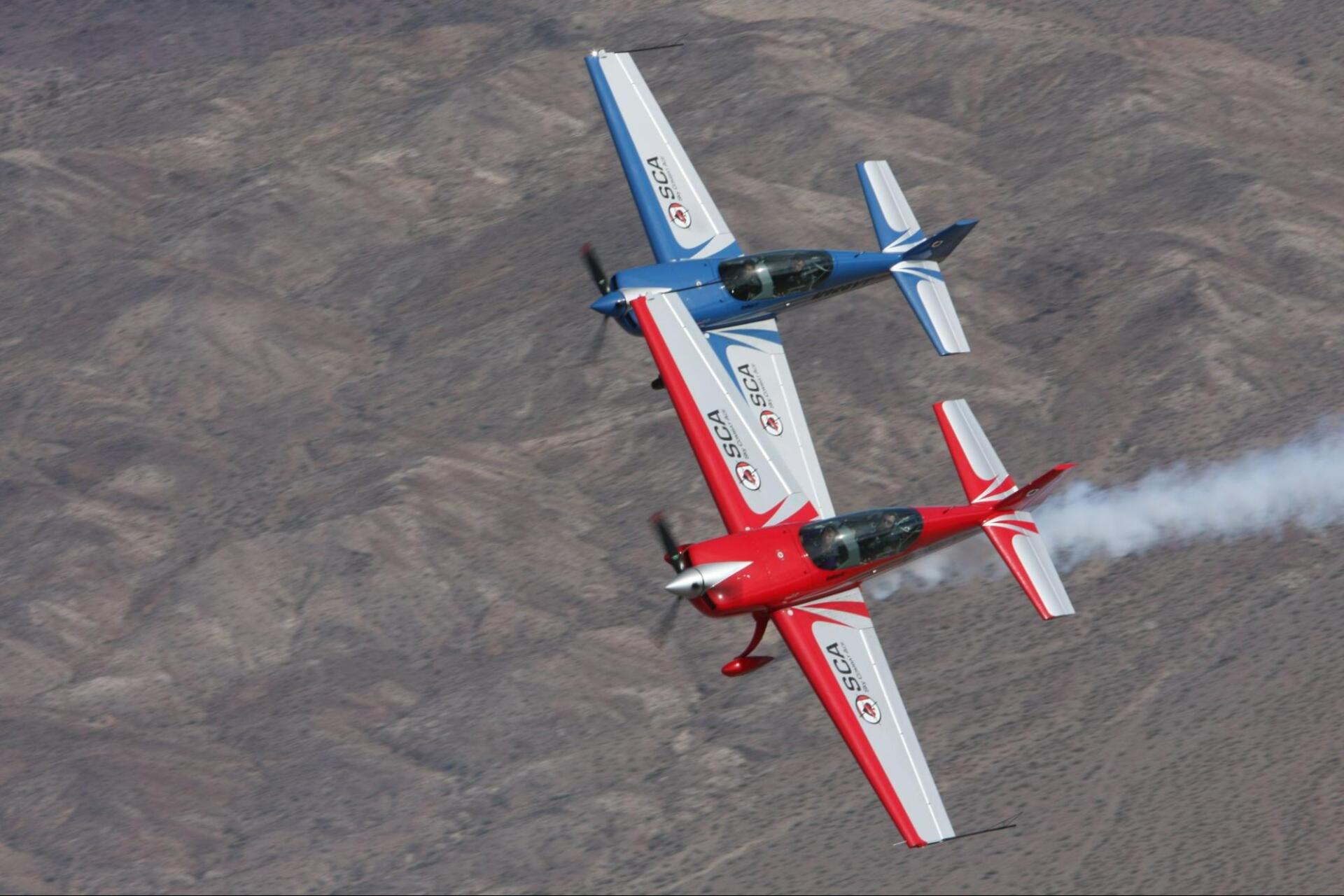 two sky combat ace stunt planes flying side by side