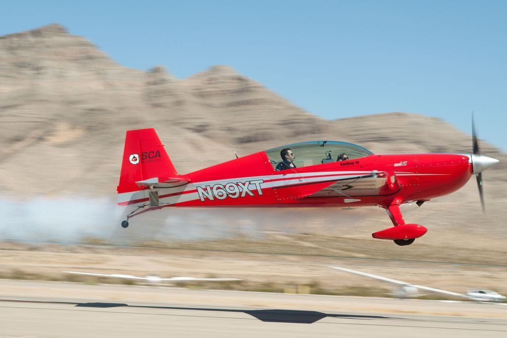 A red Sky Combat Ace plane taking off. 