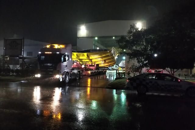 A Truck Is Driving Down a Wet Street at Night — Col Adamson Transport Pilot Services In Farleigh, QLD