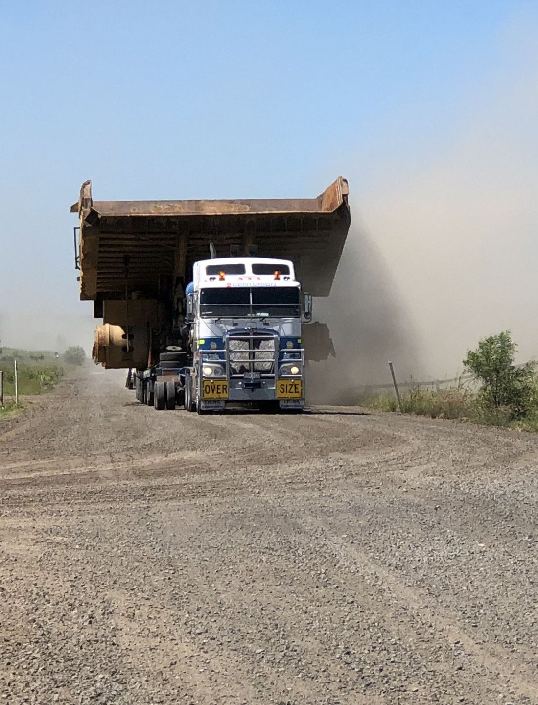 A Truck Is Driving Down a Dirt Road — Col Adamson Transport Services, Pilot Services in Farleigh, QLD