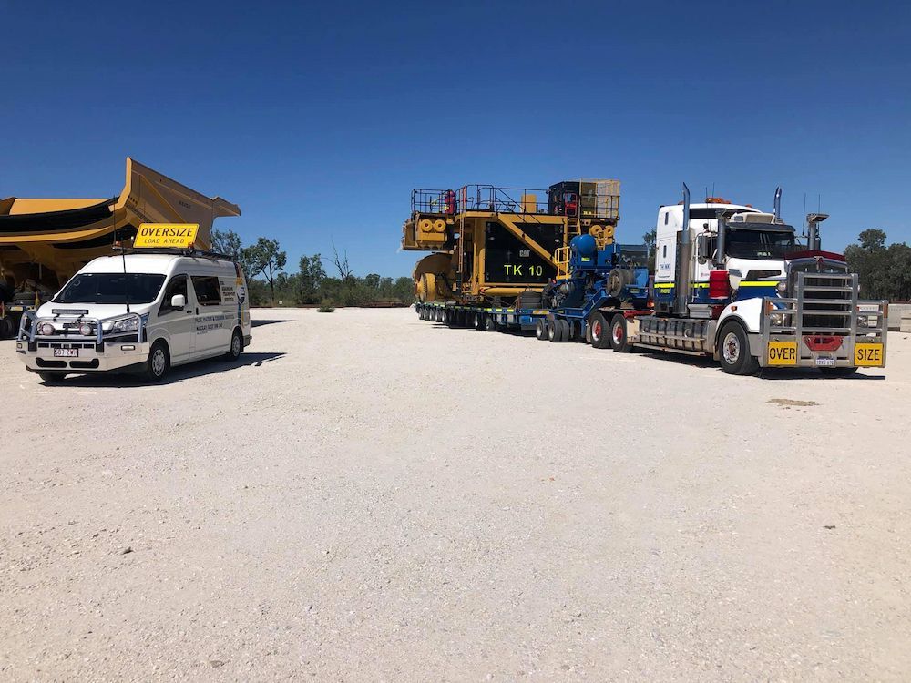 A Van and Truck Are Parked in a Gravel Lot — Col Adamson Transport Services in Farleigh, QLD