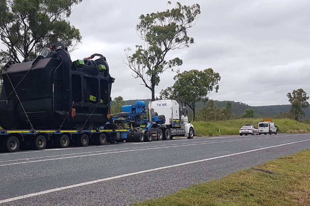 A Large Truck is Driving Down a Road — Col Adamson Transport Services in Farleigh, QLD