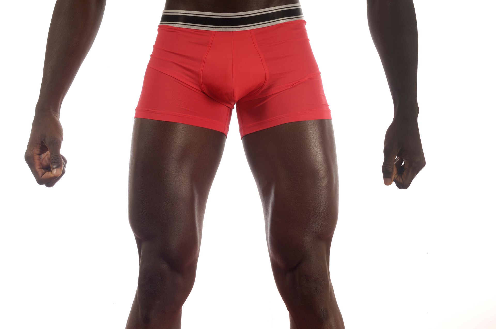 Person getting leg waxed at a salon; technician applying strip to leg.