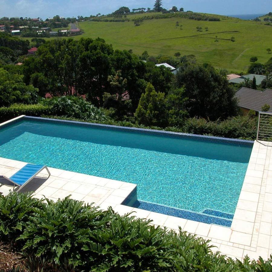 A Swimming Pool With A View Of A Field And The Ocean — Byron Bay Luxury Pools in Myocum, NSW
