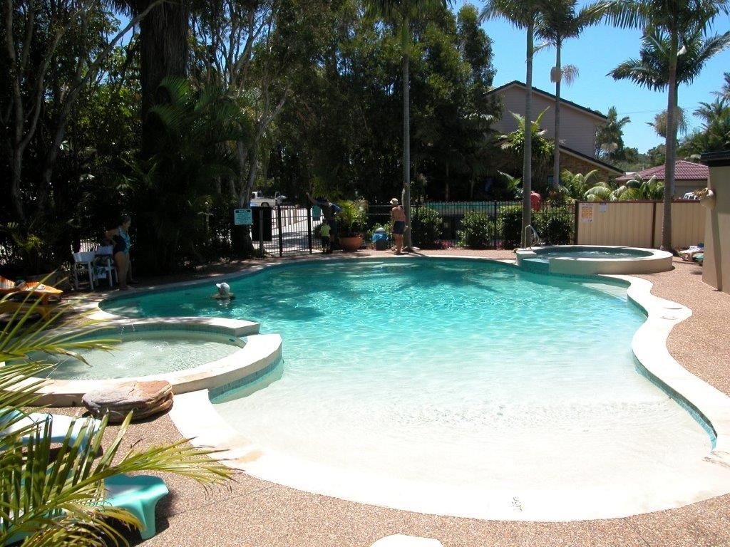 Three Adults And A Child Swimming In The Pool — Byron Bay Luxury Pools in Murwillumbah, NSW