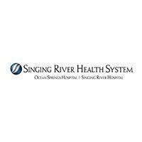 Singing River Health System logo: A blue and white circular symbol next to text that says "Singing River Health System" and its two hospitals.