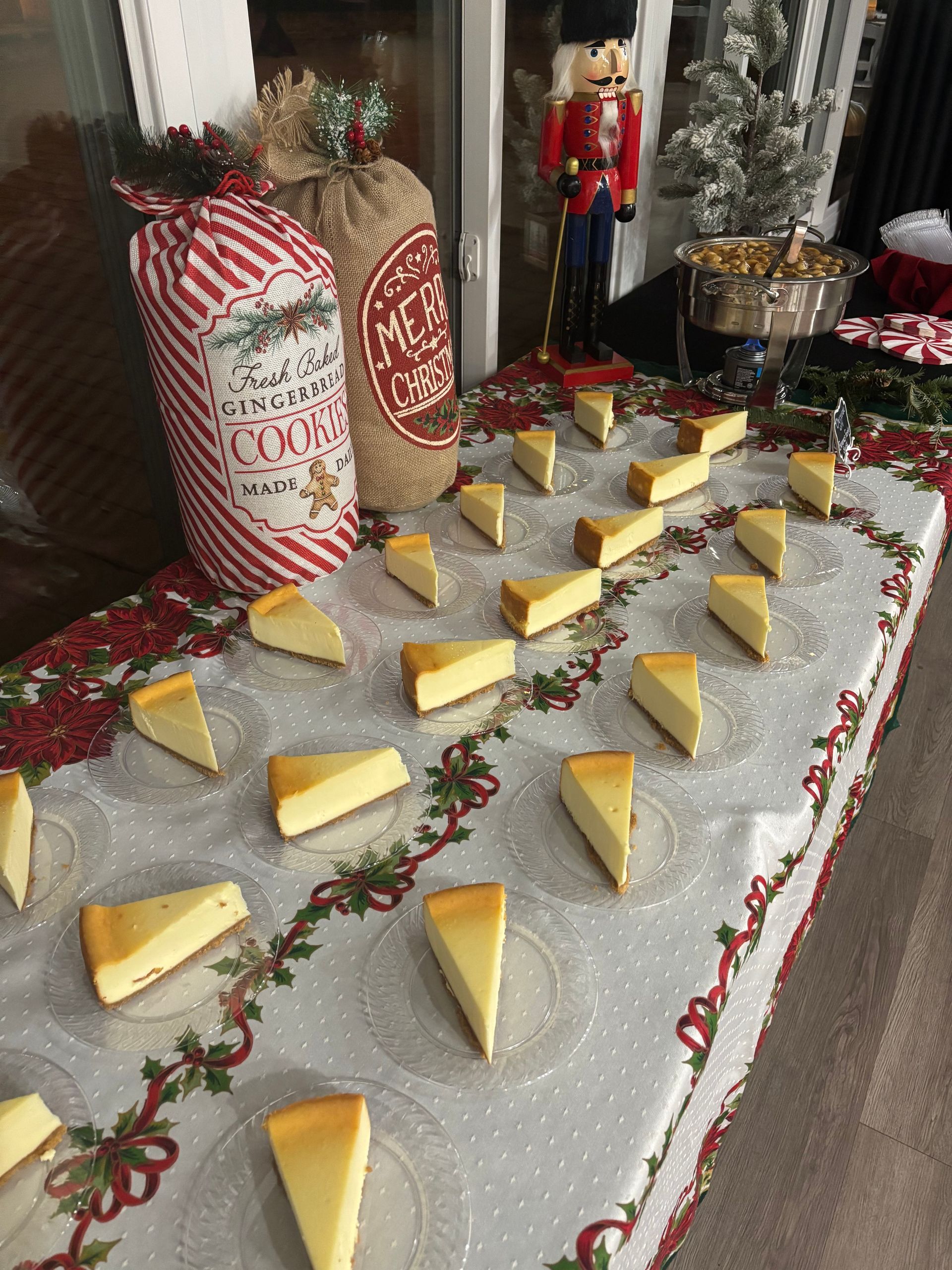 Cheesecake slices arranged on a Christmas-themed table with holiday decorations, including a nutcracker and cookie sack.