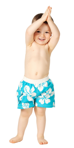Child in blue floral swim trunks, arms raised, smiling.