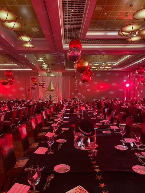 This room was illuminated with a red glow and metallic balloons in Hollywood, Florida.