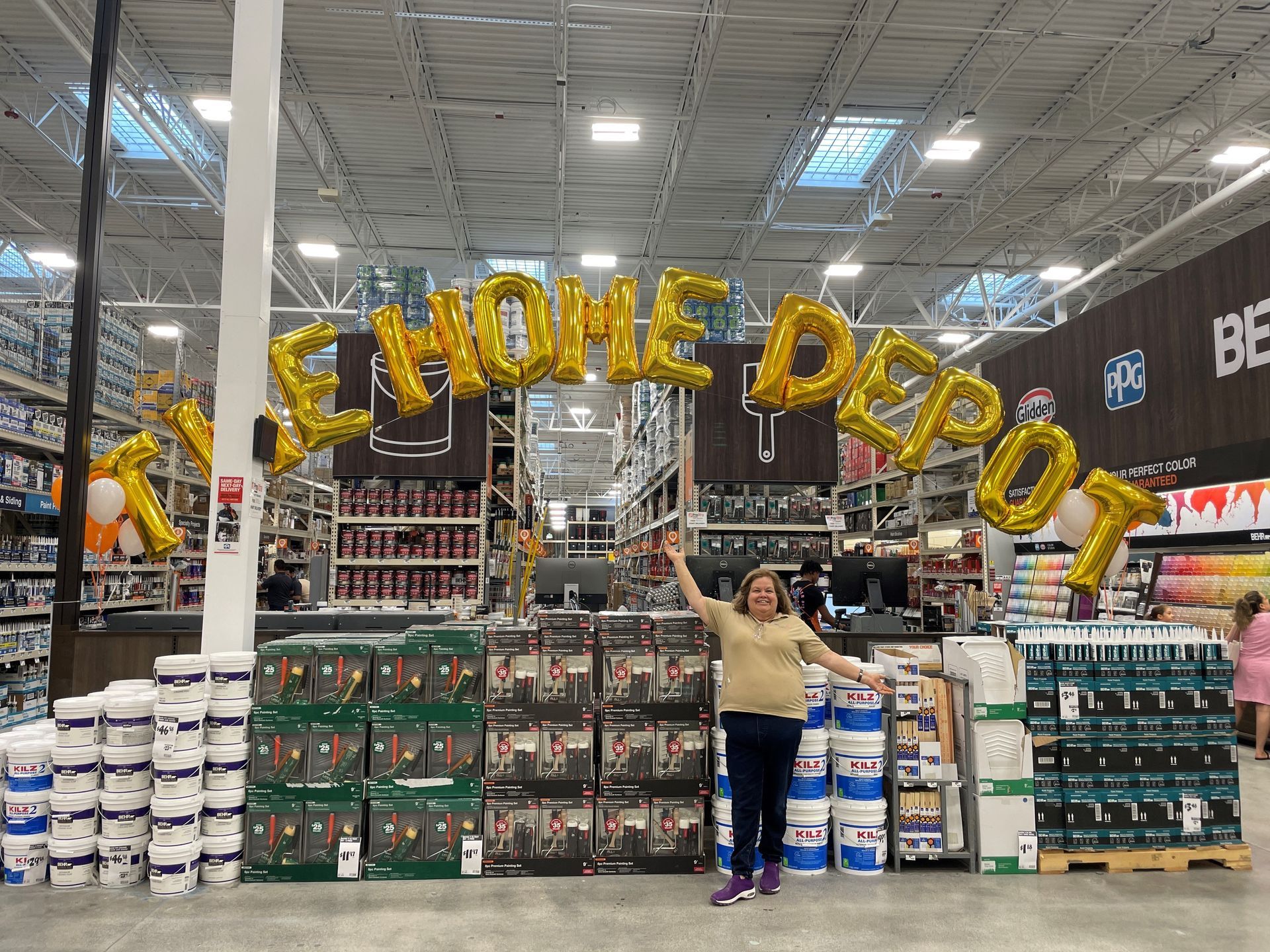 The Home Depot floating above the paint station in large gold mylar letters.