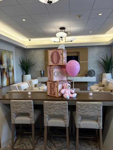 A photo of decorative boxes that are in shades of pink and reads Miss One Derful
