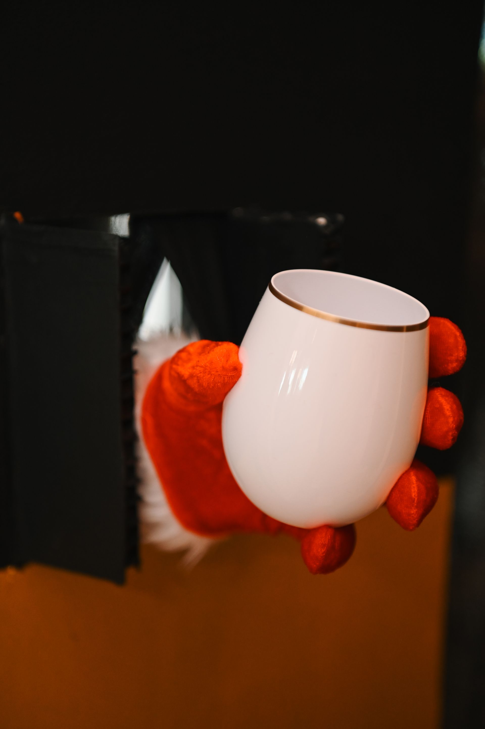 Santa's hand holding a wine glass