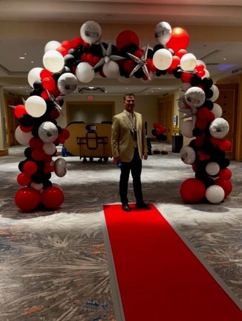 An organic balloon arch all decorated with a poker theme in Hollywood FL.