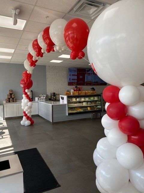 For the grand opening of Vicky's Bakery this helium string of pearl arch greeted guests.