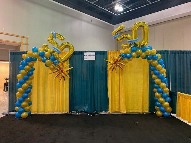 Curved balloon columns celebrating 50 years for a trade show conference