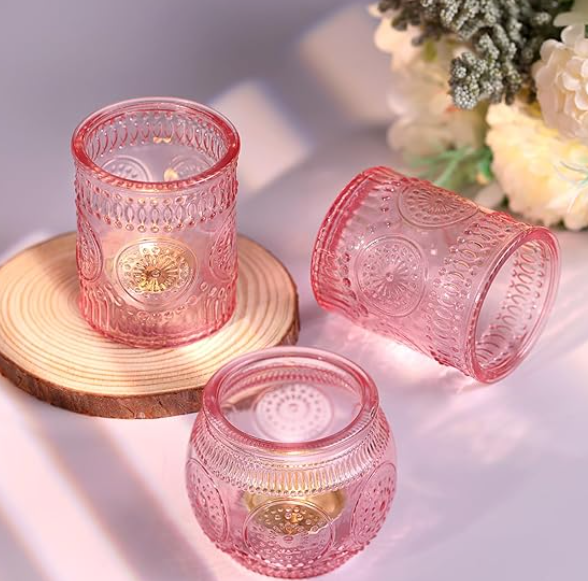 three pink votive candle holders.