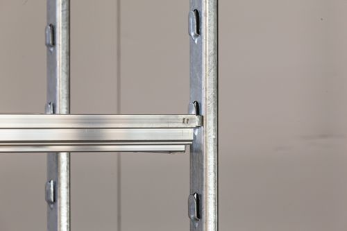 A close up of a metal ladder against a wall.