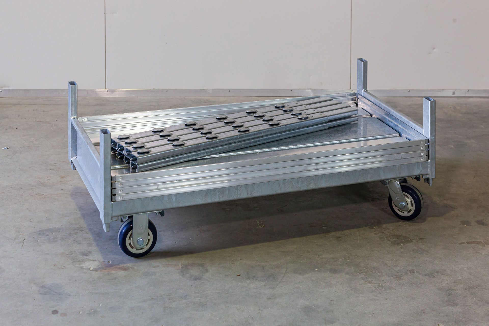 A metal cart with a metal tray on top of it.
