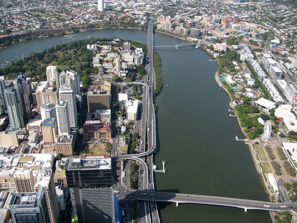 An aerial view of a bridge over a river in a city