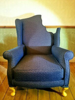 Wing back chair with bite taken out by Matt Sargent