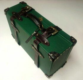 A Green Suitcase with leather straps by Matt Sargent.