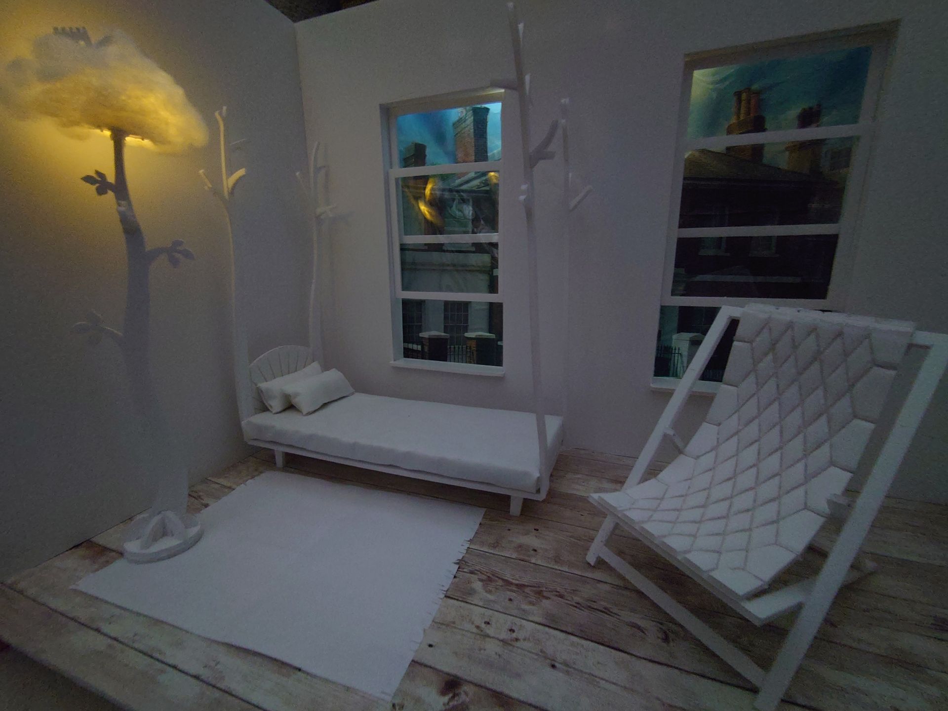 Room model with translux style, backlit window view. Containing models for deep buttoned deck chair, beanstalk childrens standard lamp and tree four poster bed.