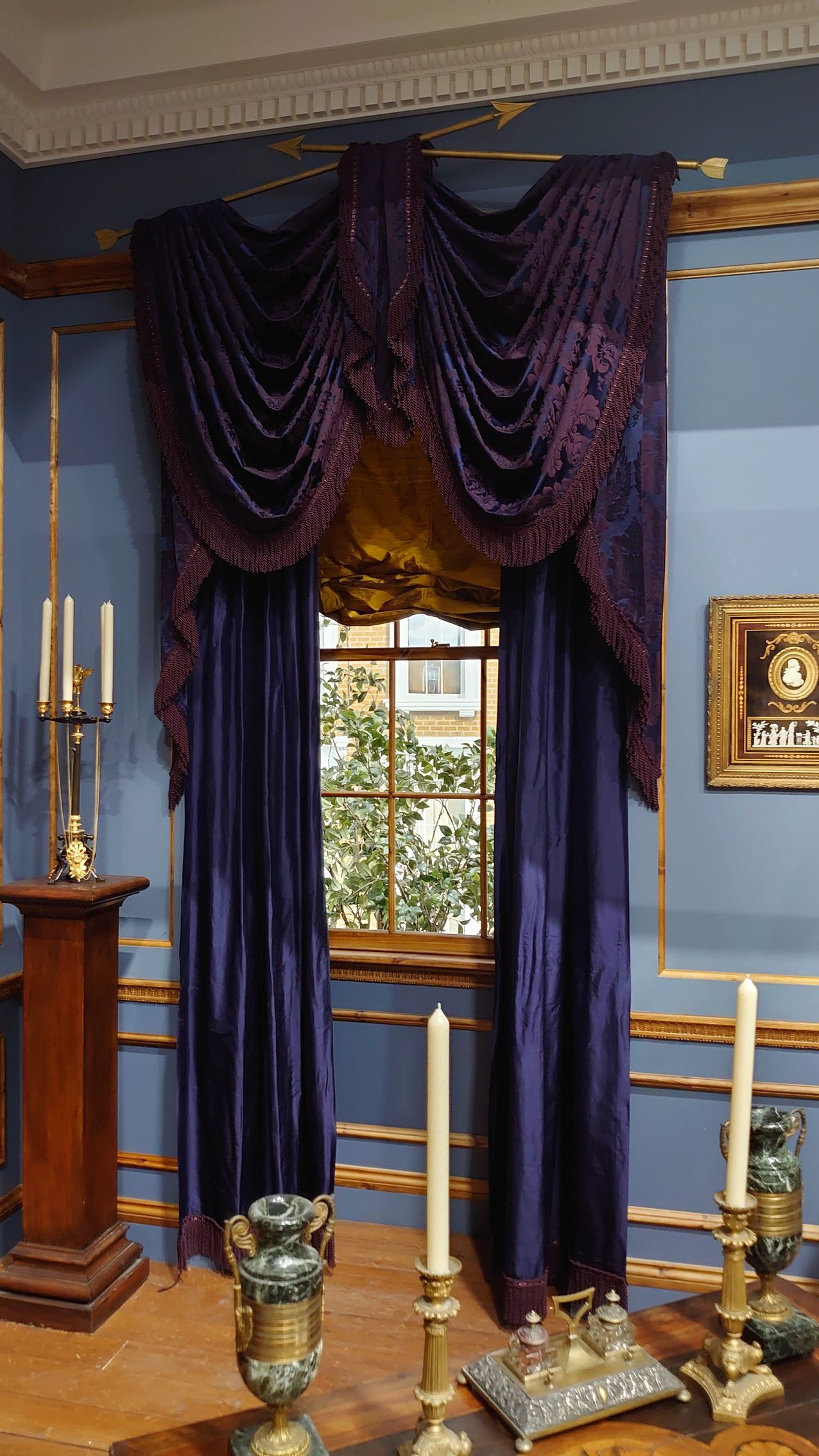 A purple velvet, ornately decorated set of swags and tails. Made for 