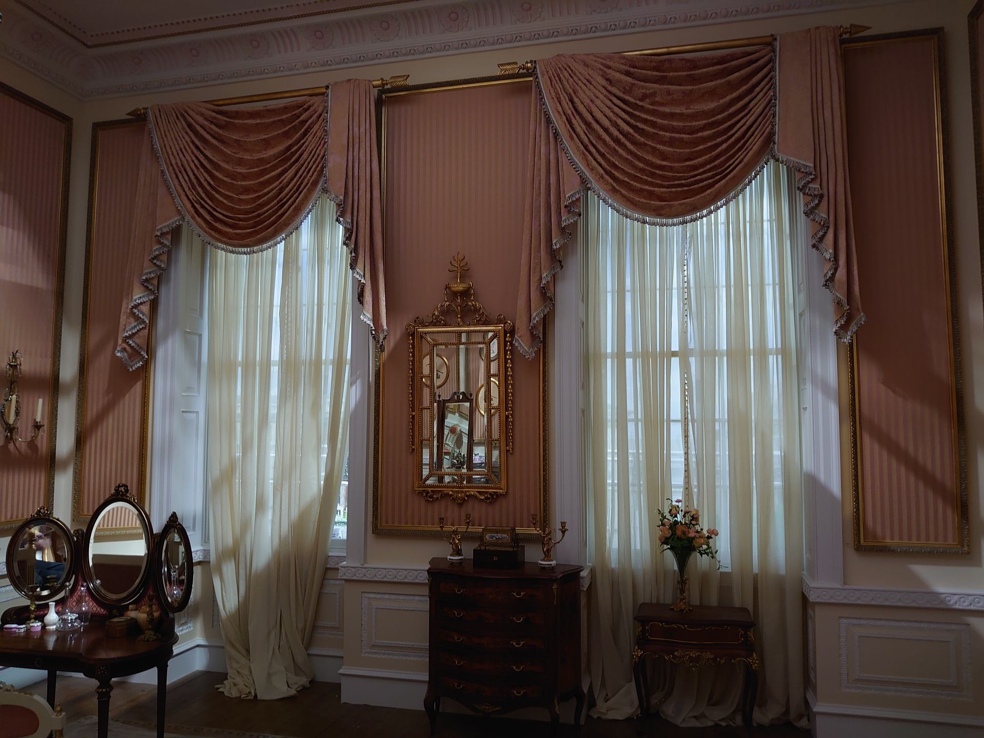 Two windows decorated with Grecian swags and tails for 