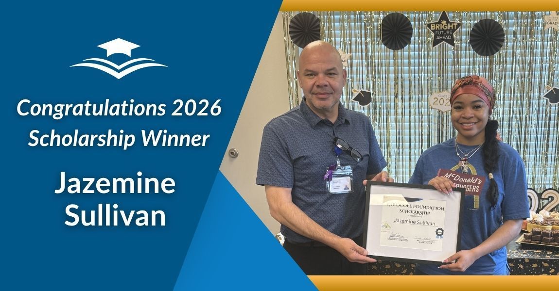2026 scholarship winner Jazemie Sullivan holds certificate with presenter beside blue backdrop
