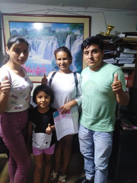 Sobre una mesa, hay un cochecito de bebé de color beige, un pequeño portavasos negro y un segundo cochecito cubierto 