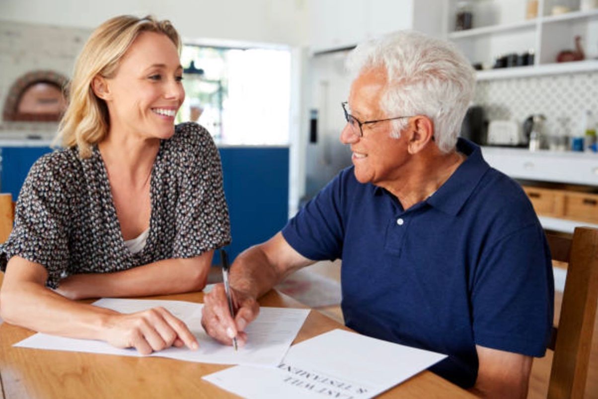 Row of townhouses with gray and tan siding, white trim, and small front porches.