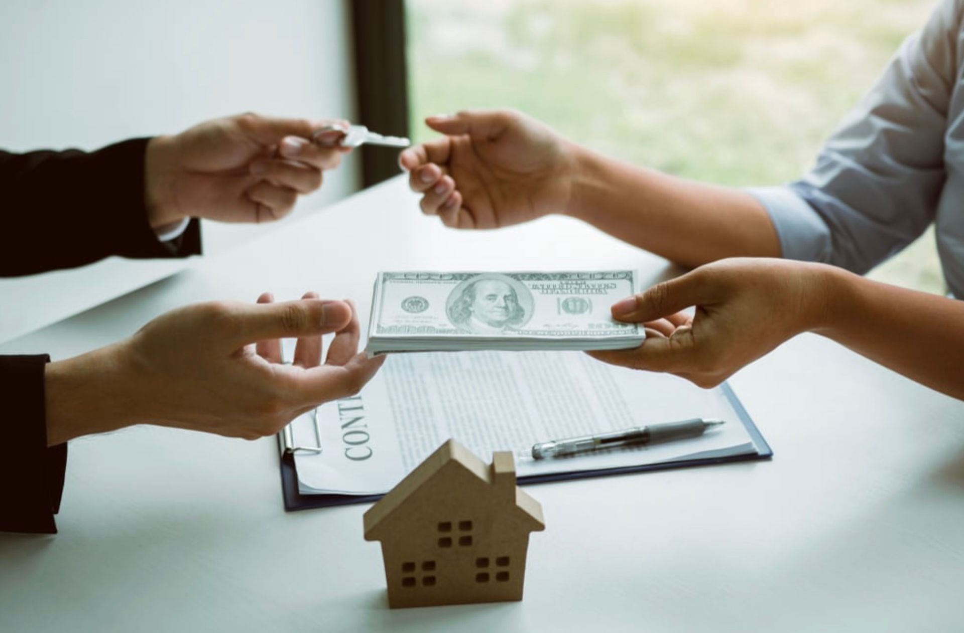 Ranch-style house with stone and siding exterior, garage, and landscaping under a cloudy sky.