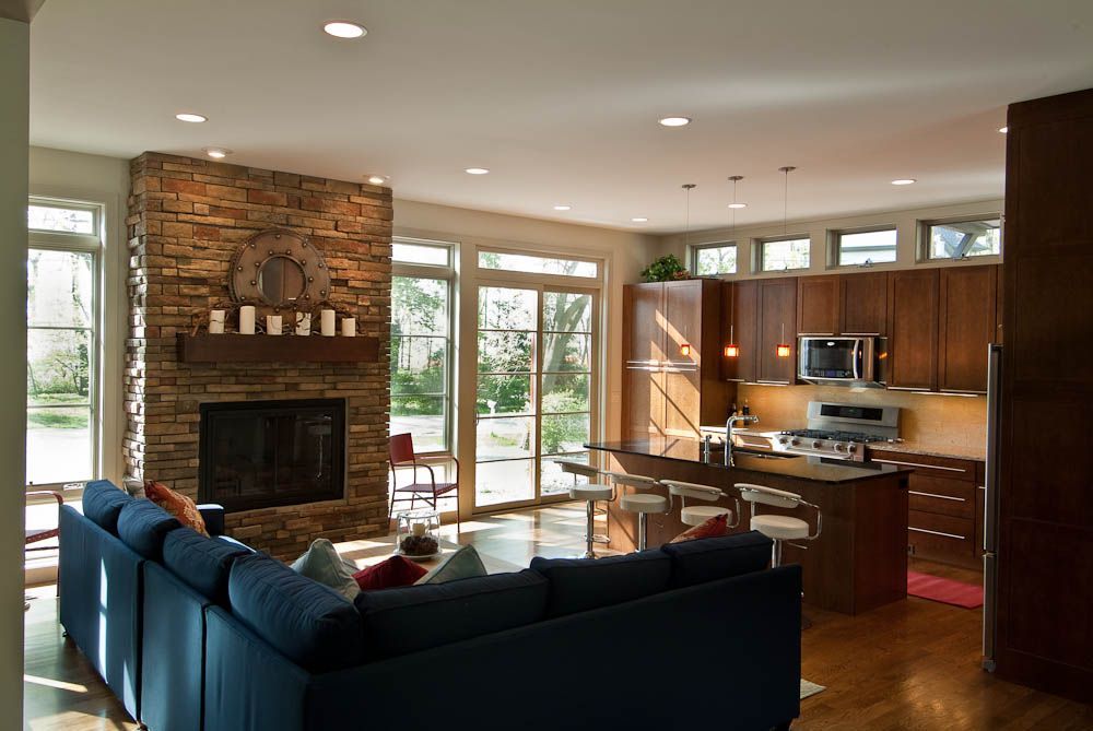 A living room with a blue couch and a fireplace