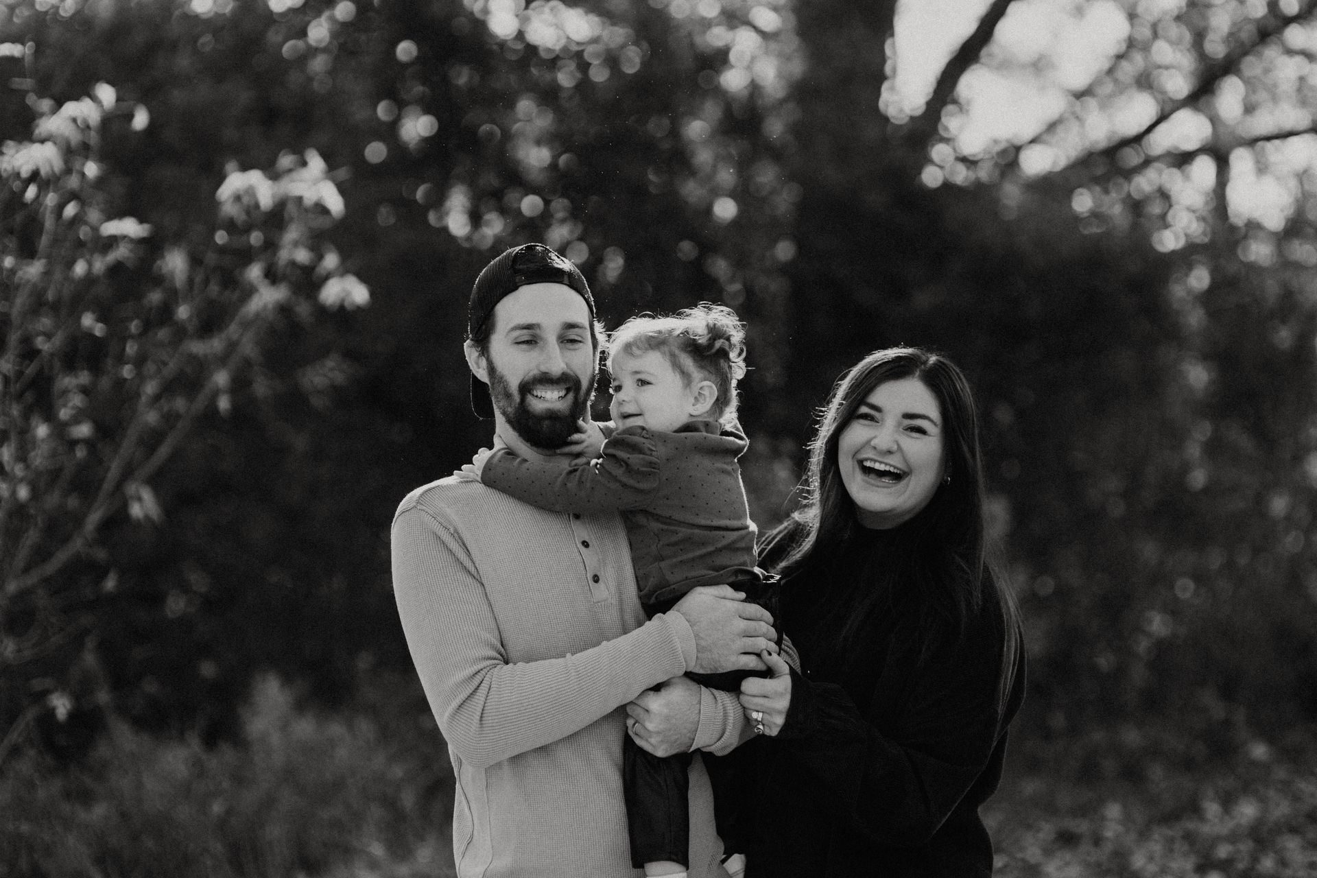 A black and white photo of a family posing for a picture.