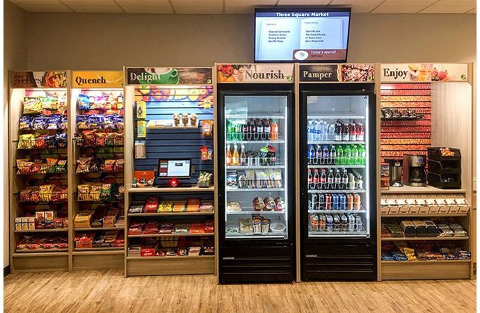 A well-stocked convenience store with snacks, drinks, and a coffee station.