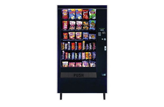 A black snack vending machine filled with various snacks and candy.