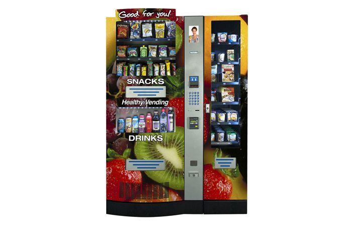 Vending machine with snacks and drinks, featuring a colorful fruit and vegetable design and numerical keypad.