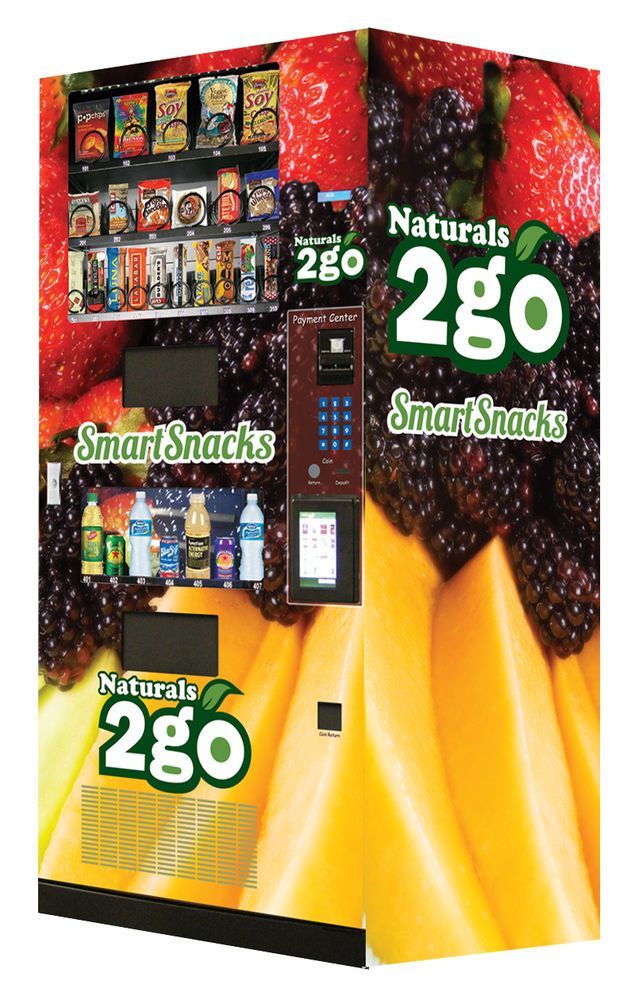 A Naturals 2go SmartSnacks vending machine with snacks and drinks, decorated with fruit images.