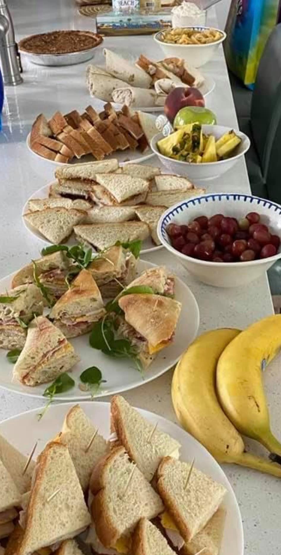 A table topped with plates of food and bananas.