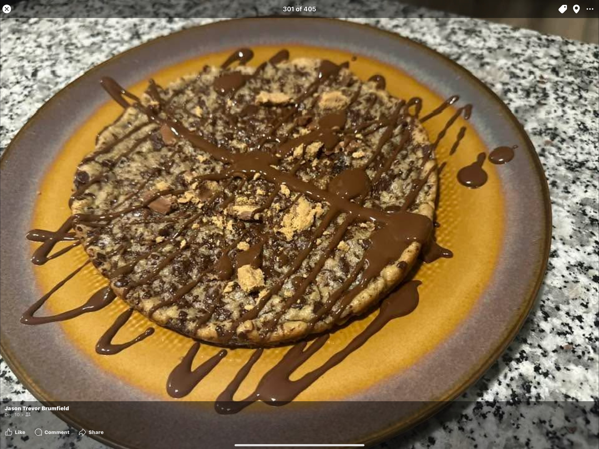 A plate of food with a cookie and chocolate sauce on it