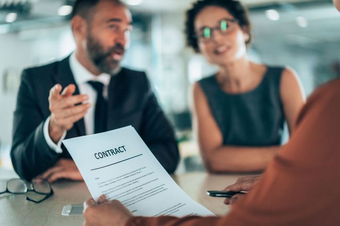 A man and a woman are sitting at a table with laptops. A man and a woman are sitting at a table with laptops.