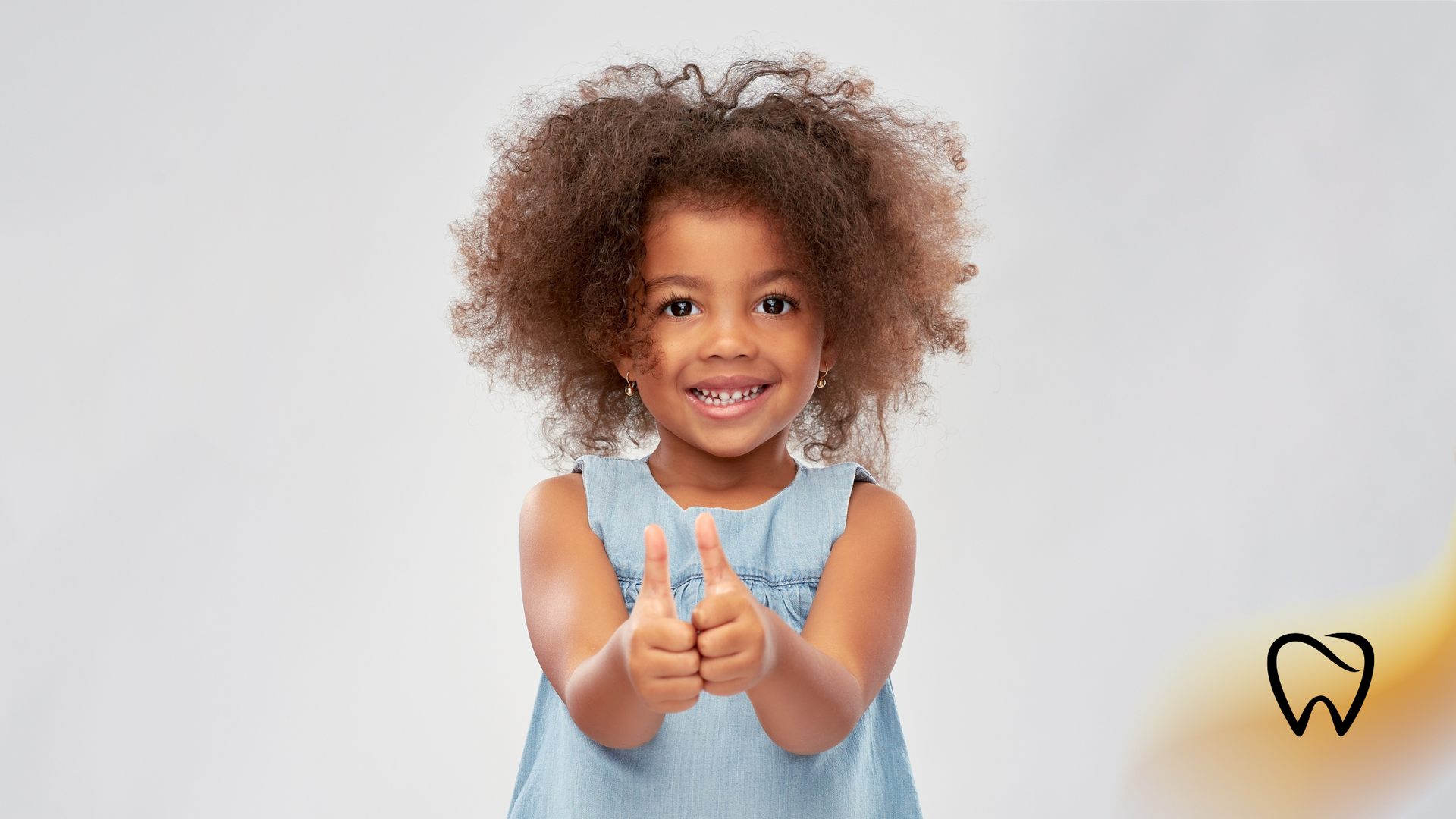 Smiling child giving two thumbs up.