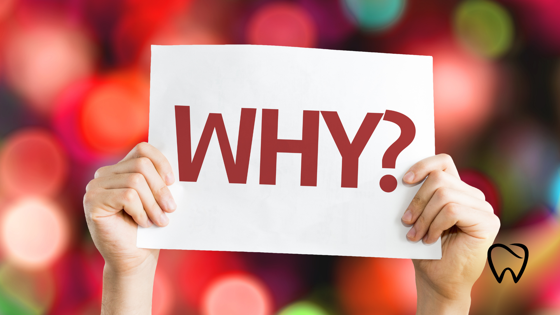 Hands holding a white sign with the word 