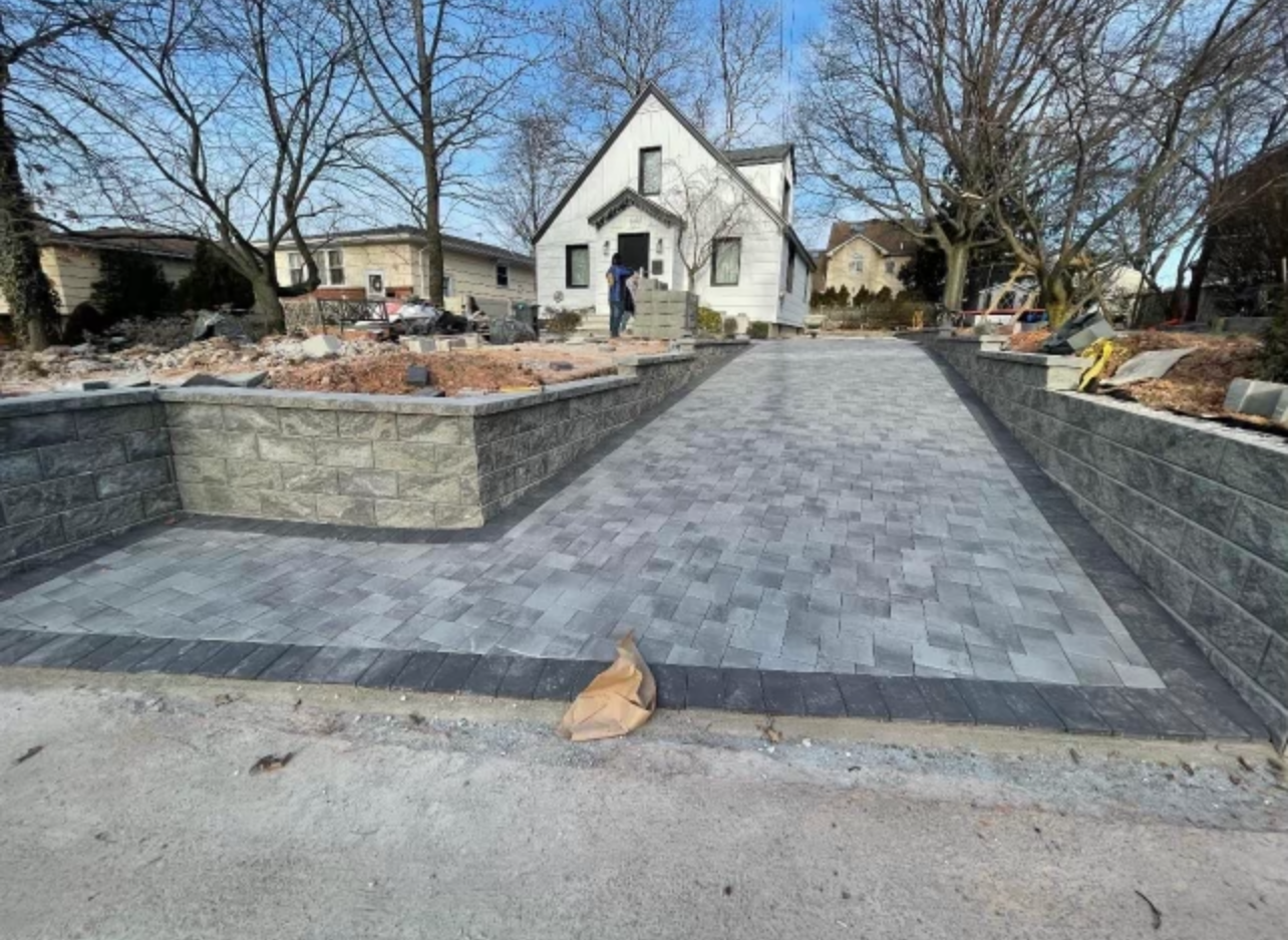 A driveway is being built in front of a house.